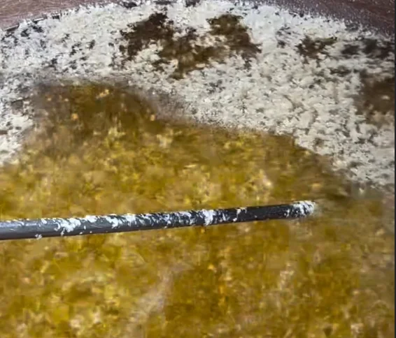 Slow heating of butter in brass vessels on wood fire